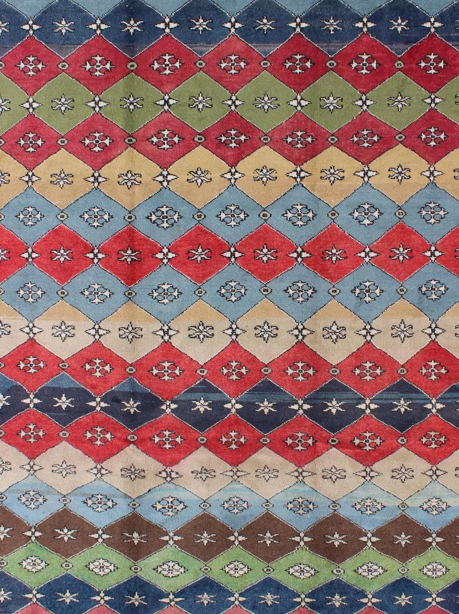 Mid - Century Rug Rendered with a multi - colored background and a spotted and speckled assortment of yellow, blue, green, red and brown colors, this very unique Mid Century rug has diamonds shapes that vary in color. Measures: 6`6 x 9` - Keivan Woven ArtsEN - 11037 - 5275Rug
