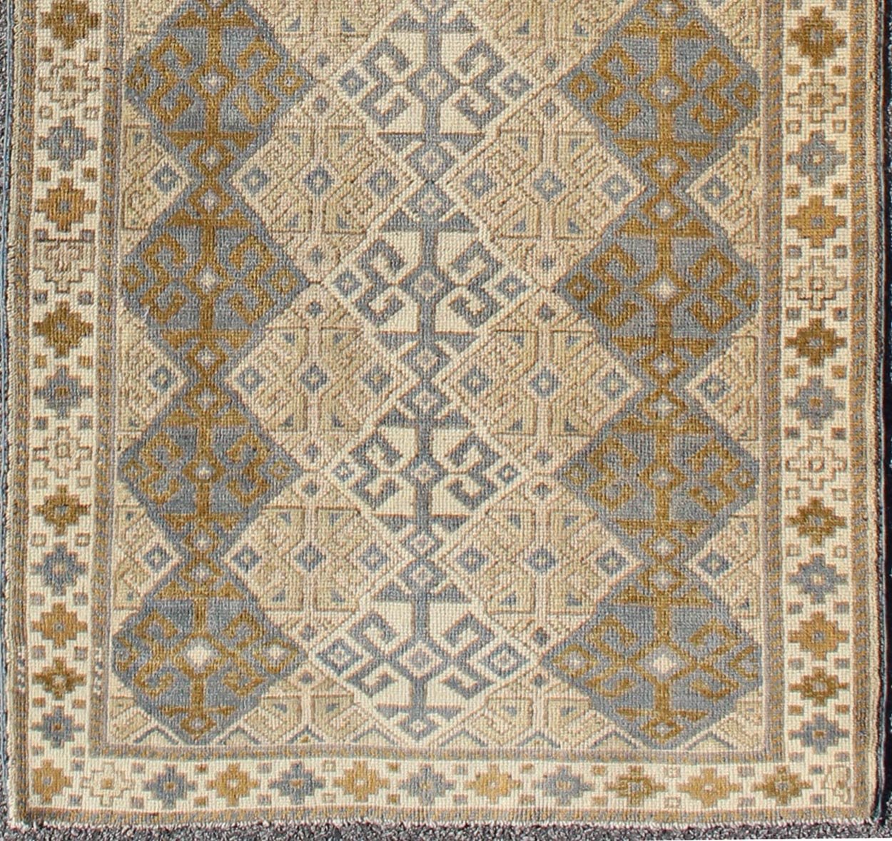 Antique Turkish Oushak Runner with Symmetrical Geometric Design Measures: 3'3 X 9'11. This rug is composed of alternating diamond motifs in different colorations that make the design more unique. The piece features, Gray blue, Camel, brown, cream... - Keivan Woven ArtsEN - 112619 - 2942Rug