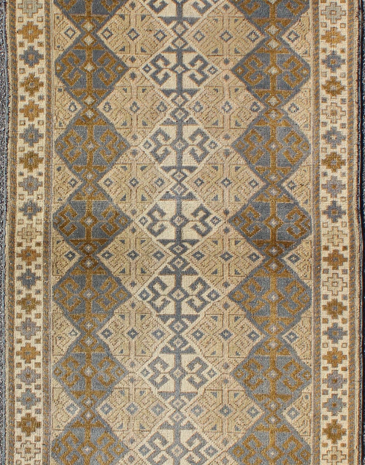 Antique Turkish Oushak Runner with Symmetrical Geometric Design Measures: 3'3 X 9'11. This rug is composed of alternating diamond motifs in different colorations that make the design more unique. The piece features, Gray blue, Camel, brown, cream... - Keivan Woven ArtsEN - 112619 - 2942Rug
