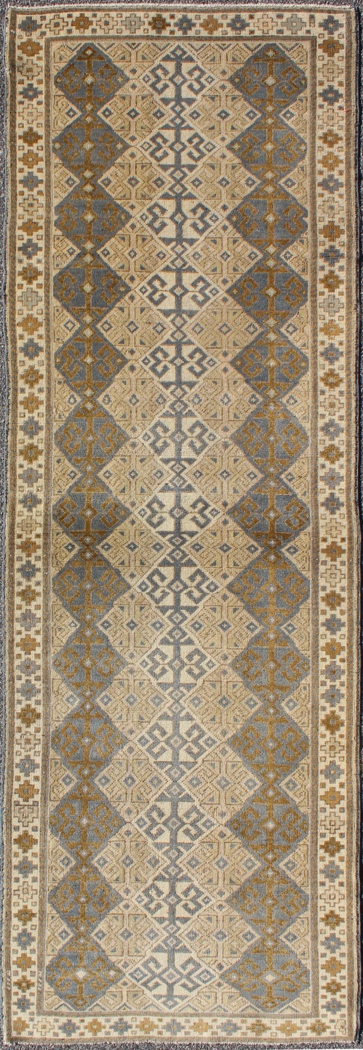 Antique Turkish Oushak Runner with Symmetrical Geometric Design Measures: 3'3 X 9'11. This rug is composed of alternating diamond motifs in different colorations that make the design more unique. The piece features, Gray blue, Camel, brown, cream... - Keivan Woven ArtsEN - 112619 - 2942Rug