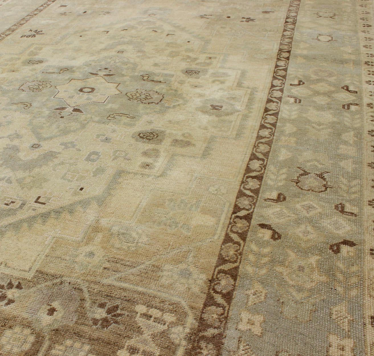 Turkish Oushak This stunning Turkish Oushak displays a gray/blue border and taupe background with brown highlights. The bold geometric design is softened by the use of subdued and pale colors. Measures: 6'4 x 9'4. - Keivan Woven ArtsEN - 112721 - 4900Rug