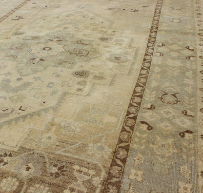 Turkish Oushak This stunning Turkish Oushak displays a gray/blue border and taupe background with brown highlights. The bold geometric design is softened by the use of subdued and pale colors. Measures: 6'4 x 9'4. - Keivan Woven ArtsEN - 112721 - 4900Rug