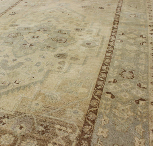 Turkish Oushak This stunning Turkish Oushak displays a gray/blue border and taupe background with brown highlights. The bold geometric design is softened by the use of subdued and pale colors. Measures: 6'4 x 9'4. - Keivan Woven ArtsEN - 112721 - 4900Rug