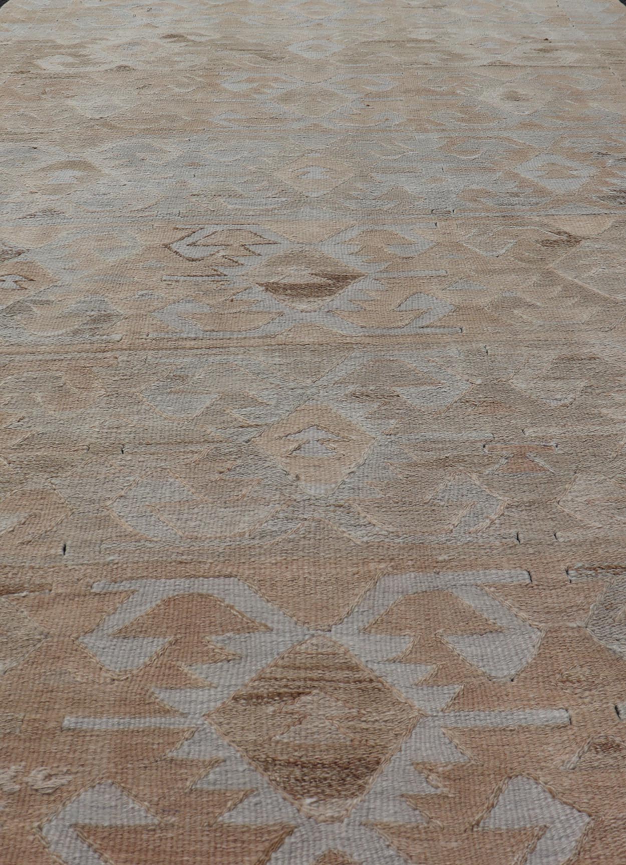 Gallery Turkish Vintage Flat - Weave Tribal Designed Kilim in Earthy Tones Measures: 5 x 10'1 This vintage Turkish flat weave Kilim features tribal relics and faded earthy neutrals. The repeating design covers the entire field of muted li... - Keivan Woven ArtsEN - 113 - 18782