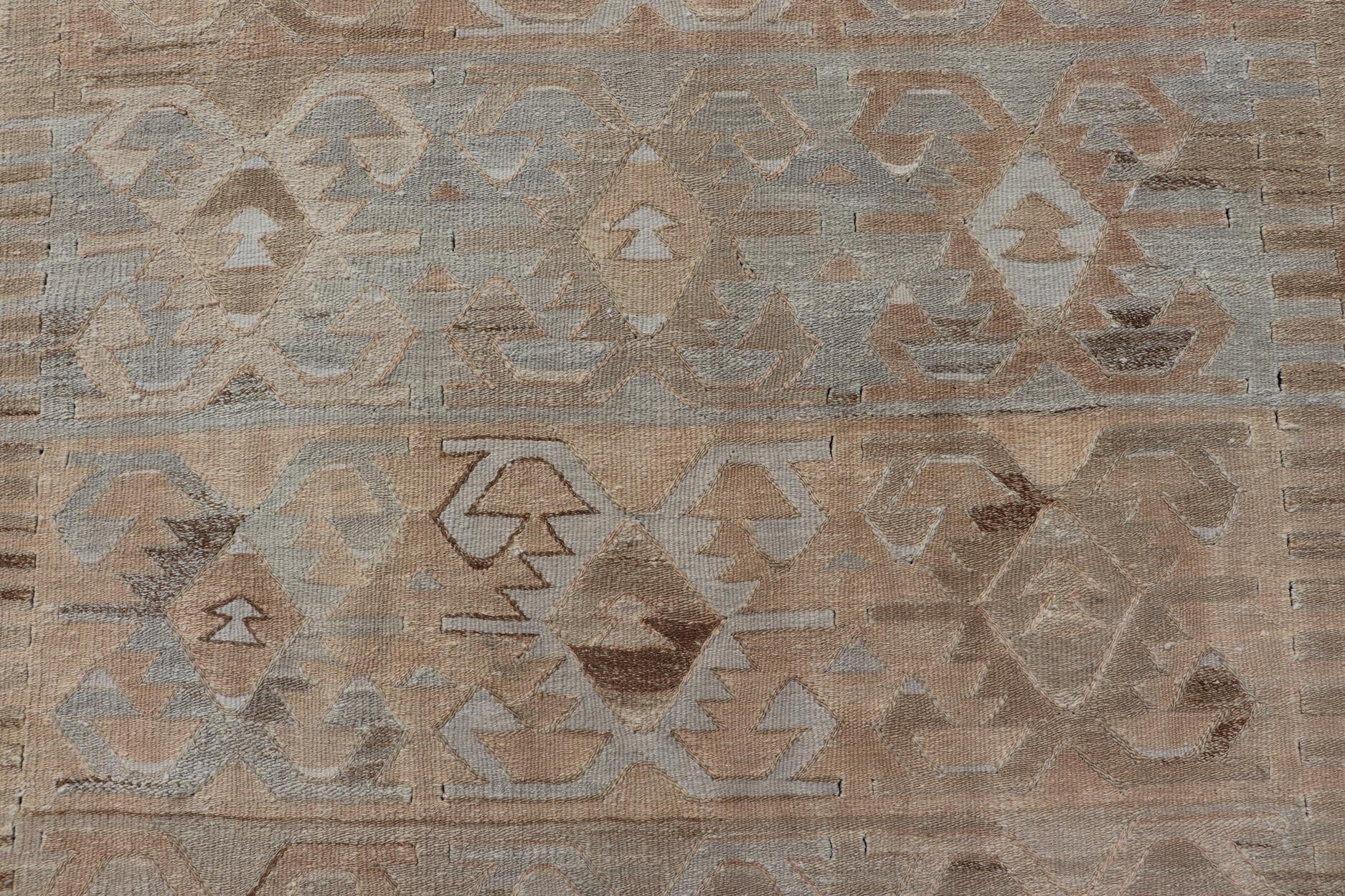 Gallery Turkish Vintage Flat - Weave Tribal Designed Kilim in Earthy Tones Measures: 5 x 10'1 This vintage Turkish flat weave Kilim features tribal relics and faded earthy neutrals. The repeating design covers the entire field of muted li... - Keivan Woven ArtsEN - 113 - 18782