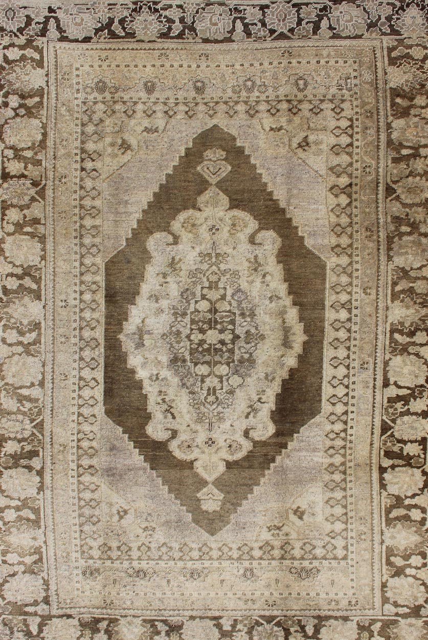 Vintage Turkish Oushak Rug This Turkish Oushak is set on taupe background with a medium brown colors. The border displays flower pattern with connecting vines. Measures: 5'8 x 8'3. - Keivan Woven ArtsEN - 115623 - 2101Rug