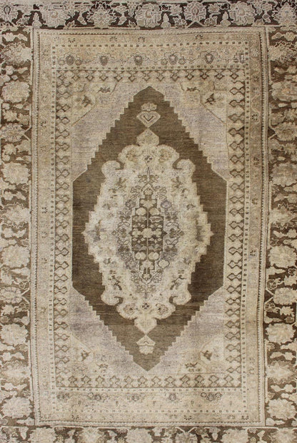 Vintage Turkish Oushak Rug This Turkish Oushak is set on taupe background with a medium brown colors. The border displays flower pattern with connecting vines. Measures: 5'8 x 8'3. - Keivan Woven ArtsEN - 115623 - 2101Rug