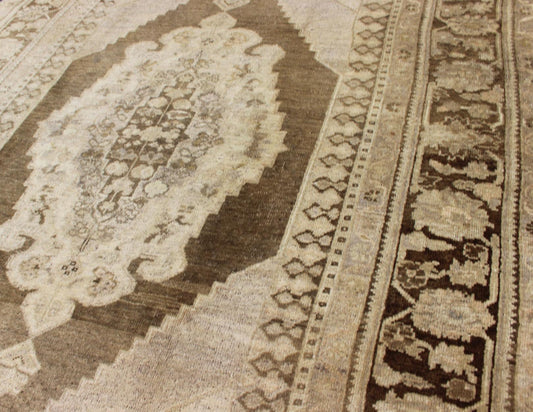 Vintage Turkish Oushak Rug This Turkish Oushak is set on taupe background with a medium brown colors. The border displays flower pattern with connecting vines. Measures: 5'8 x 8'3. - Keivan Woven ArtsEN - 115623 - 2101Rug