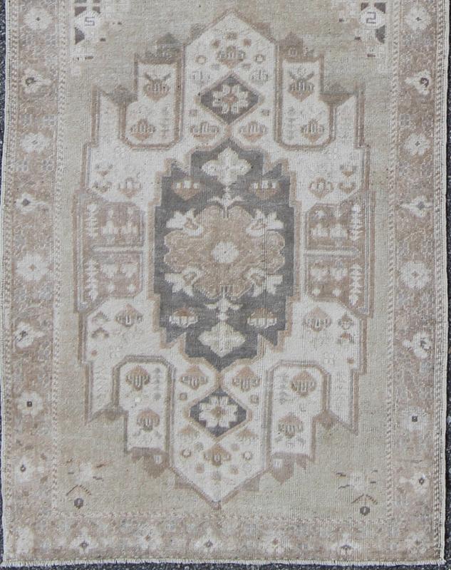 Turkish Oushak Runner with Central Medallion Design in Taupe, Charcoal and Gray kwarugs This Turkish vintage Oushak runner features a central medallion design as well as patterns of smaller botanical elements. Colors include various shades o... - Keivan Woven ArtsEN - 115826 - 2093Rug