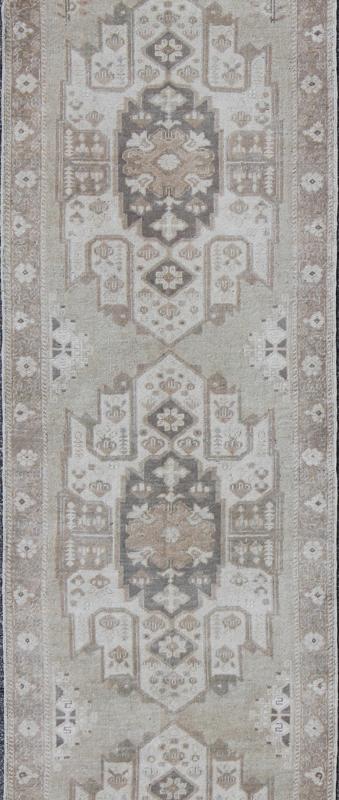 Turkish Oushak Runner with Central Medallion Design in Taupe, Charcoal and Gray kwarugs This Turkish vintage Oushak runner features a central medallion design as well as patterns of smaller botanical elements. Colors include various shades o... - Keivan Woven ArtsEN - 115826 - 2093Rug