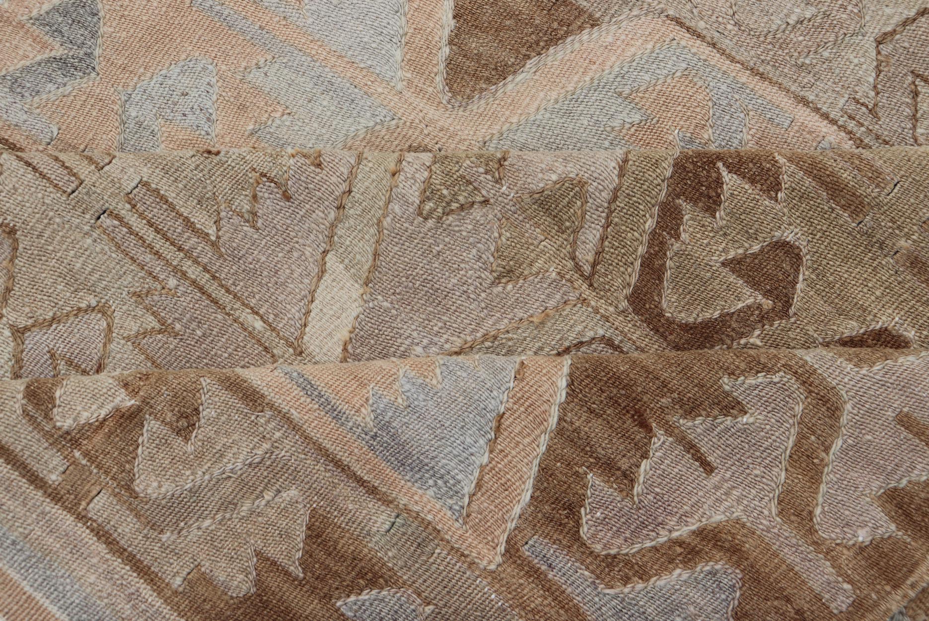 Vintage Hand - Woven Turkish Kilim Gallery Rug in Wool with Sub - Geometric Design This flat - weave tribal Turkish kilim has been hand - woven in wool. The rug features an all - over sub - geometric design, rendered in grays blues and earthy tones; making... - Keivan Woven ArtsEN - 122 - 19244