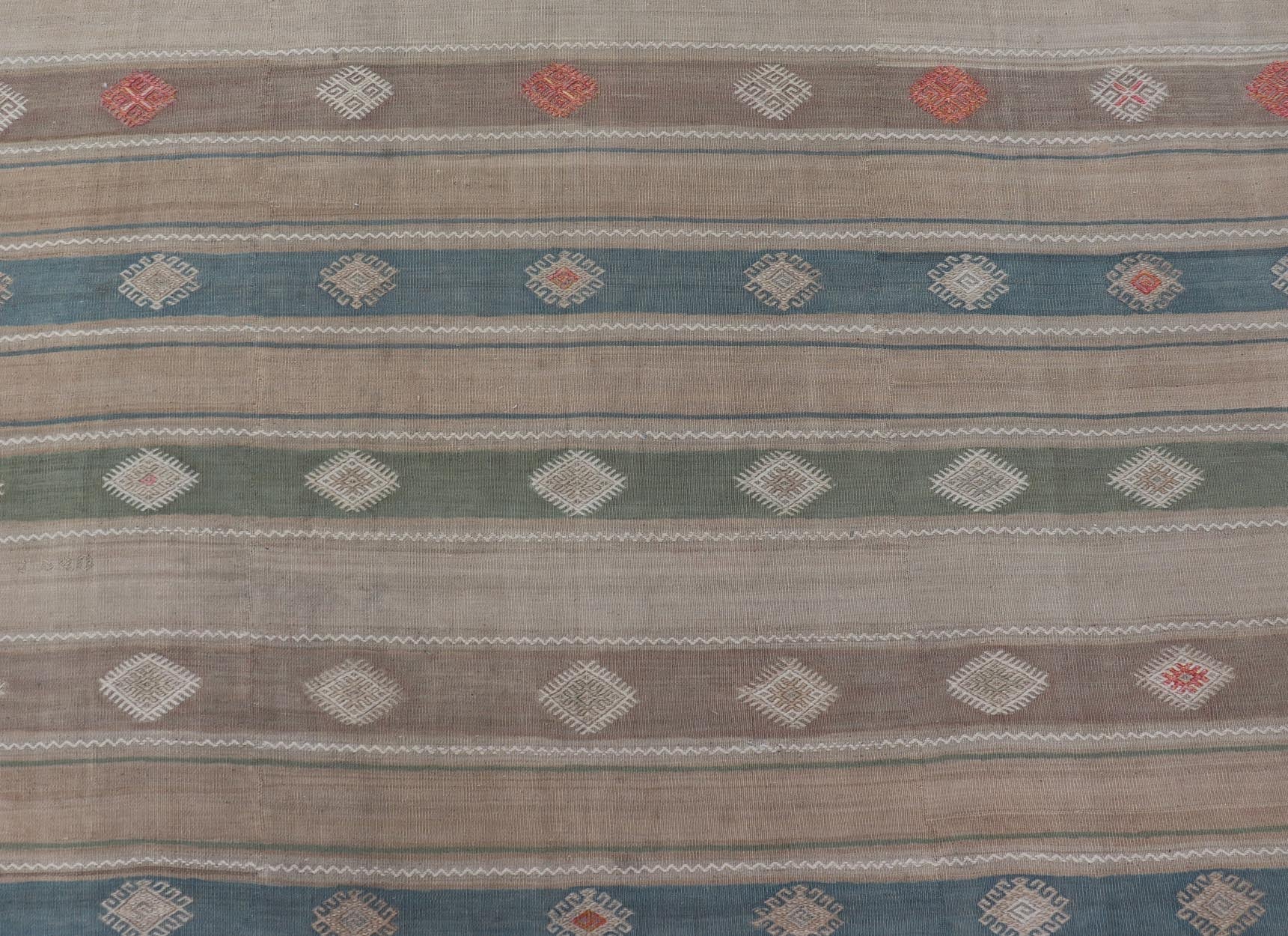 Vintage Hand - Woven Flatweave Kilim in Wool with Sub - Geometric Design and Motifs This flat - weave tribal kilim has been hand - woven in wool. The rug features a horizontal stripe design, accentuated by various sub - geometric motifs. The rug has been... - Keivan Woven ArtsEN - 13103 - 15725