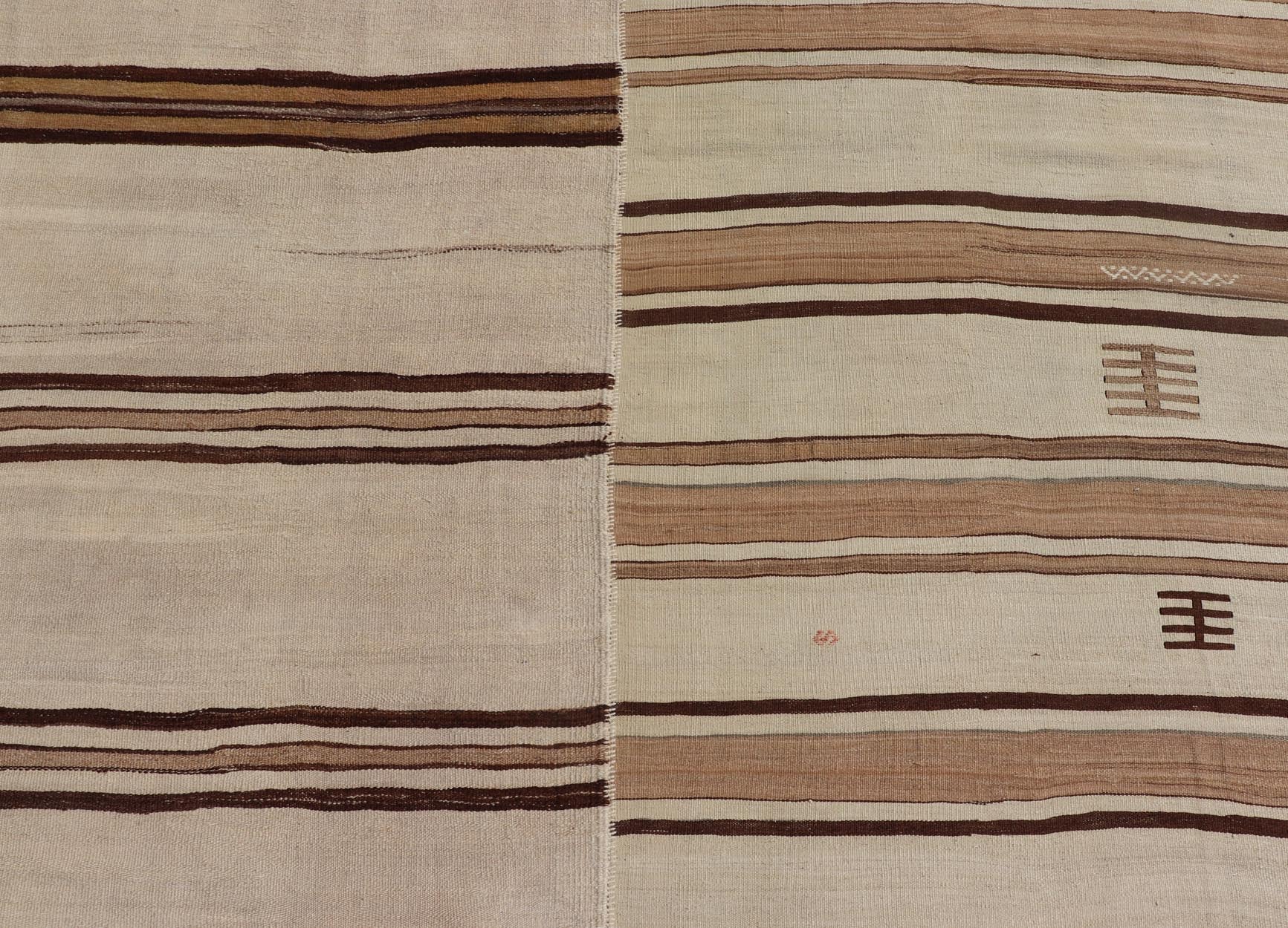 Large Vintage Flat - Woven Turkish Paneled Kilim Rug in Wool with Stripe Design This flat - weave tribal Turkish kilim has been hand - woven in wool. The rug features an sub - geometric striped design, and is rendered earthy tones; making this rug a su... - Keivan Woven ArtsEN - 13113 - 178719 - 178838 - 19748