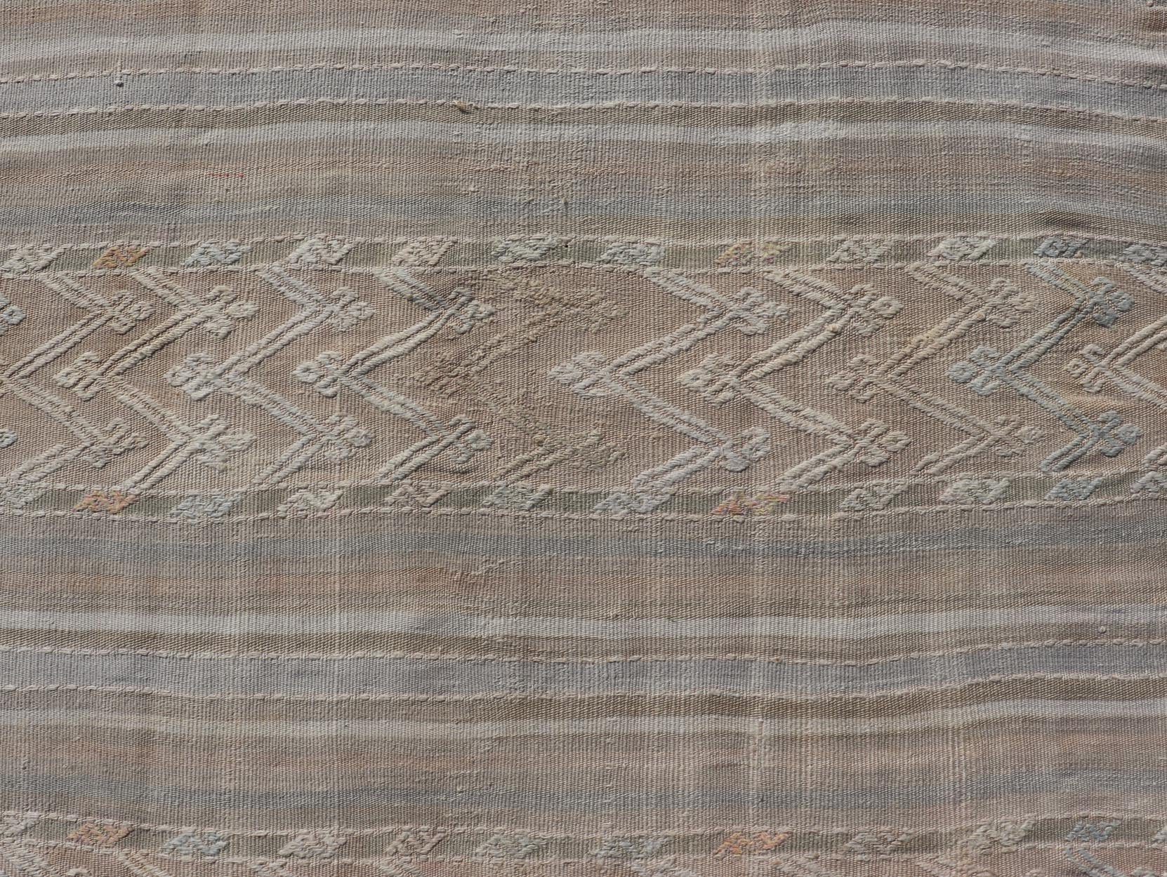 Striped Hand Woven Turkish Flat - Weave Kilim in Muted Colors and Tribal Motifs Turkish Kilim vintage carpet in muted colors and design with tribal motifs. Keivan Woven Arts / rug EN - 179780, country of origin / type: Turkey / Kilim , circa 1950... - Keivan Woven ArtsEN - 13478 - 18812Rug