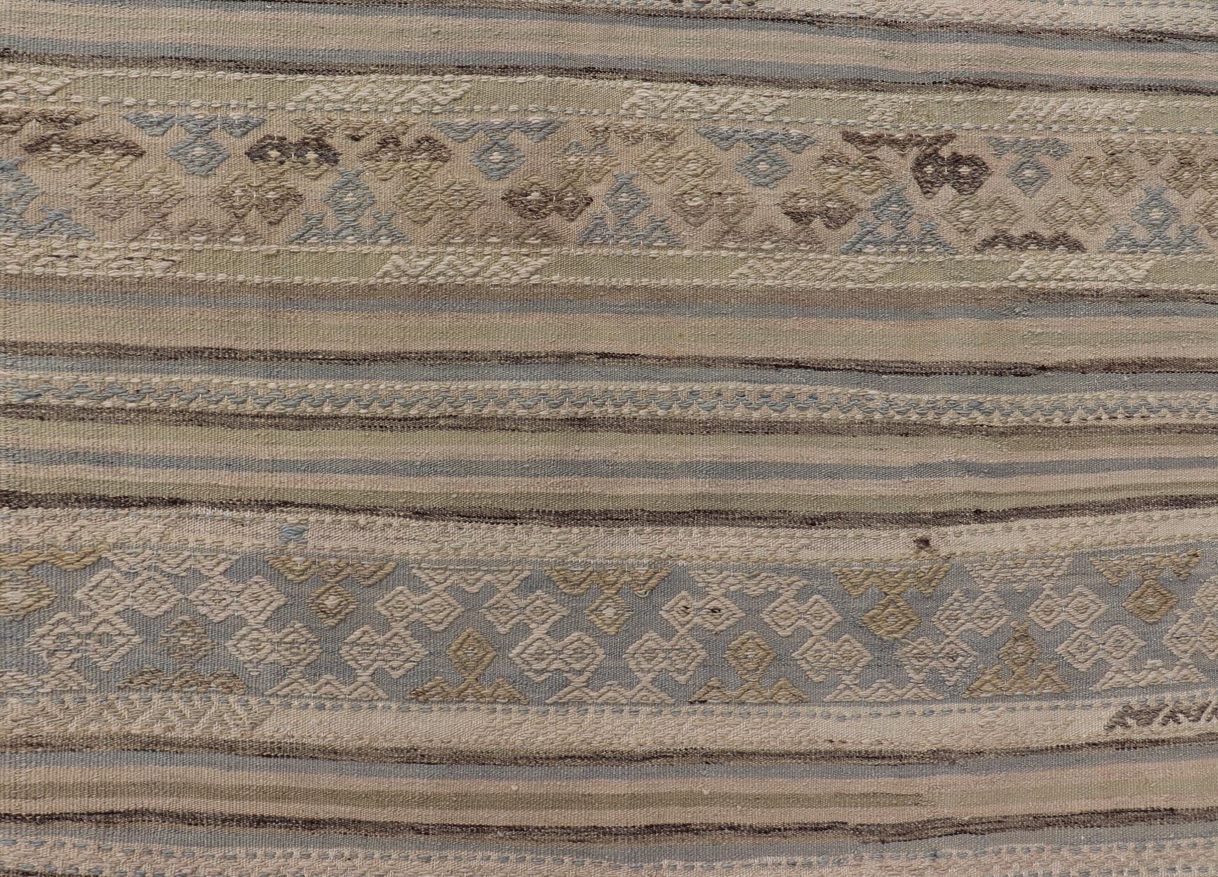 Measures: 5'3 x 9'0 Turkish Vintage Kilim With Embroidered Motifs in Earthy Tones with Blue - Gray. Keivan Woven Arts / rug EN - 13495, country of origin / type: Turkey / Kilim, circa 1950 This flat - woven Kilim from Turkey features an enticing c... - Keivan Woven ArtsEN - 13495 - 21727Rug