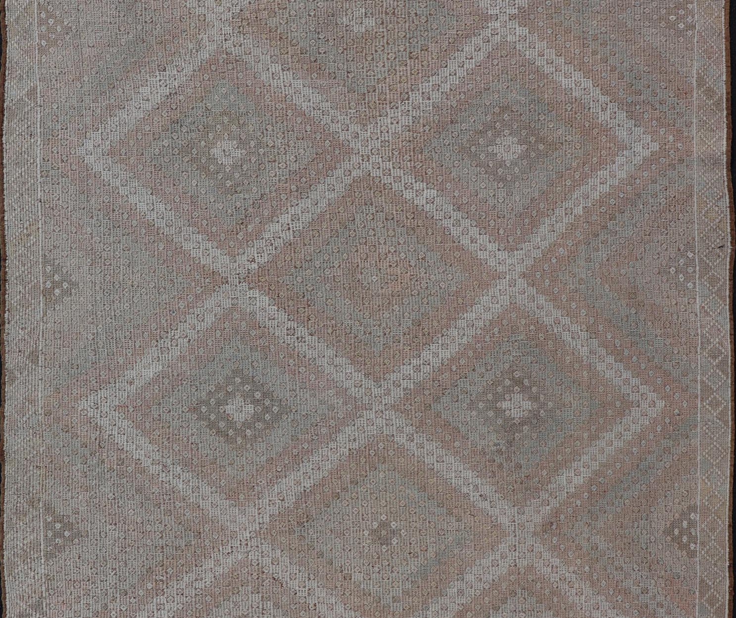 Vintage Turkish Embroidered Rug with Geometric Diamond Design with Soft Colors Embroidered vintage rug from Turkey in shades of tan, light green, light red, and cream with geometric pattern, Keivan Woven Arts / rug EN - 13652, country of origin / ... - Keivan Woven ArtsEN - 13652 - 18830Rug