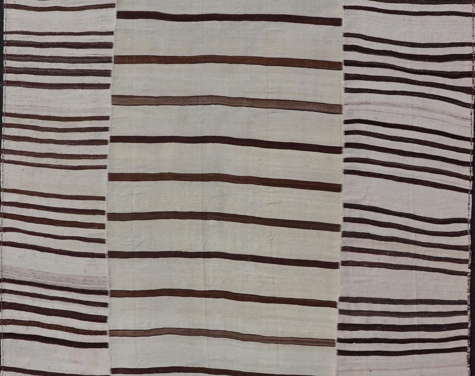 Vintage Hand - Woven Turkish Kilim in Wool with Sub - Geometric Striped Panel Design This flat - weave tribal Turkish kilim has been hand - woven in wool. The rug features an all - over sub - geometric striped panel design, rendered in earthy tones; making... - Keivan Woven ArtsEN - 13689 - 13213 - 19490