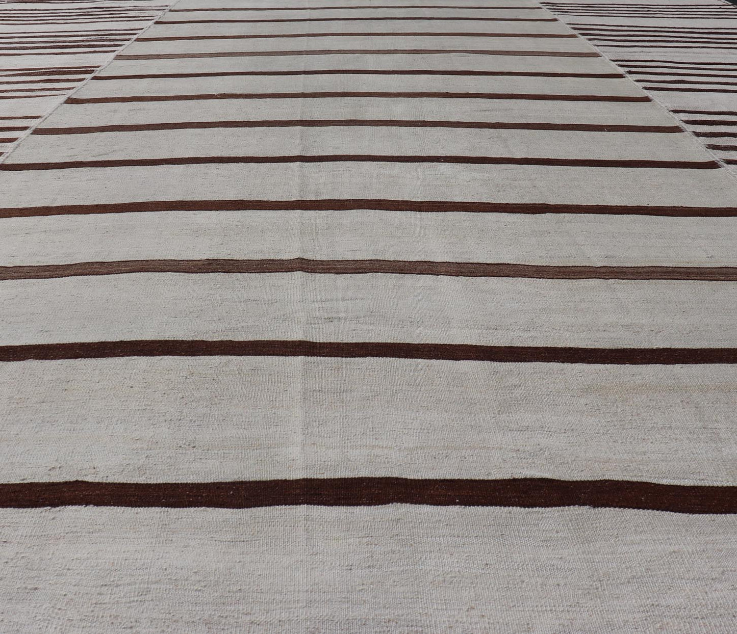 Vintage Hand - Woven Turkish Kilim in Wool with Sub - Geometric Striped Panel Design This flat - weave tribal Turkish kilim has been hand - woven in wool. The rug features an all - over sub - geometric striped panel design, rendered in earthy tones; making... - Keivan Woven ArtsEN - 13689 - 13213 - 19490