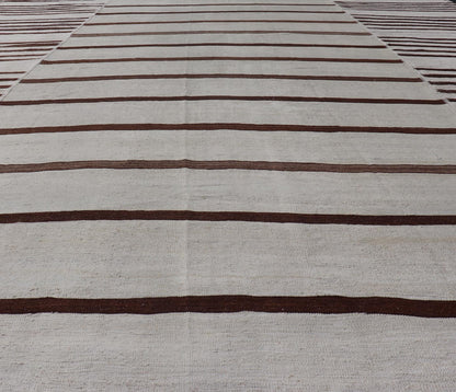 Vintage Hand - Woven Turkish Kilim in Wool with Sub - Geometric Striped Panel Design This flat - weave tribal Turkish kilim has been hand - woven in wool. The rug features an all - over sub - geometric striped panel design, rendered in earthy tones; making... - Keivan Woven ArtsEN - 13689 - 13213 - 19490