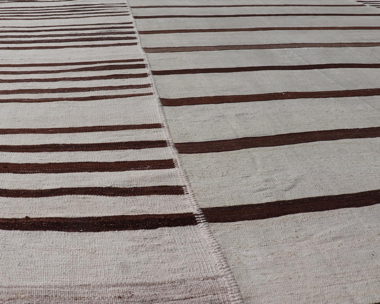 Vintage Hand - Woven Turkish Kilim in Wool with Sub - Geometric Striped Panel Design This flat - weave tribal Turkish kilim has been hand - woven in wool. The rug features an all - over sub - geometric striped panel design, rendered in earthy tones; making... - Keivan Woven ArtsEN - 13689 - 13213 - 19490