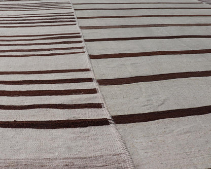 Vintage Hand - Woven Turkish Kilim in Wool with Sub - Geometric Striped Panel Design This flat - weave tribal Turkish kilim has been hand - woven in wool. The rug features an all - over sub - geometric striped panel design, rendered in earthy tones; making... - Keivan Woven ArtsEN - 13689 - 13213 - 19490