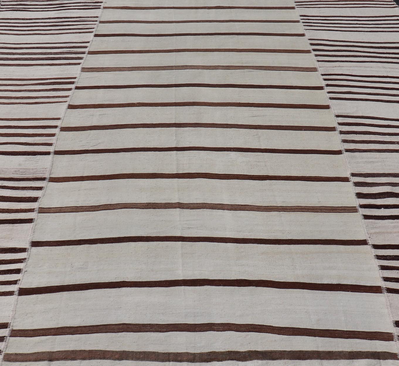Vintage Hand - Woven Turkish Kilim in Wool with Sub - Geometric Striped Panel Design This flat - weave tribal Turkish kilim has been hand - woven in wool. The rug features an all - over sub - geometric striped panel design, rendered in earthy tones; making... - Keivan Woven ArtsEN - 13689 - 13213 - 19490