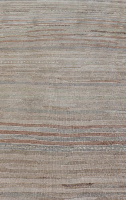 Minimalist Striped Design Vintage Turkish Kilim with Neutral Tones Measures 3'9 x 6'0 This wonderful piece features easy colors and a simple design. The palette consists of muted reds and blues, accenting the camel, fawn, and cocoa mass. ... - Keivan Woven ArtsEN - 13942 - 18926Rug