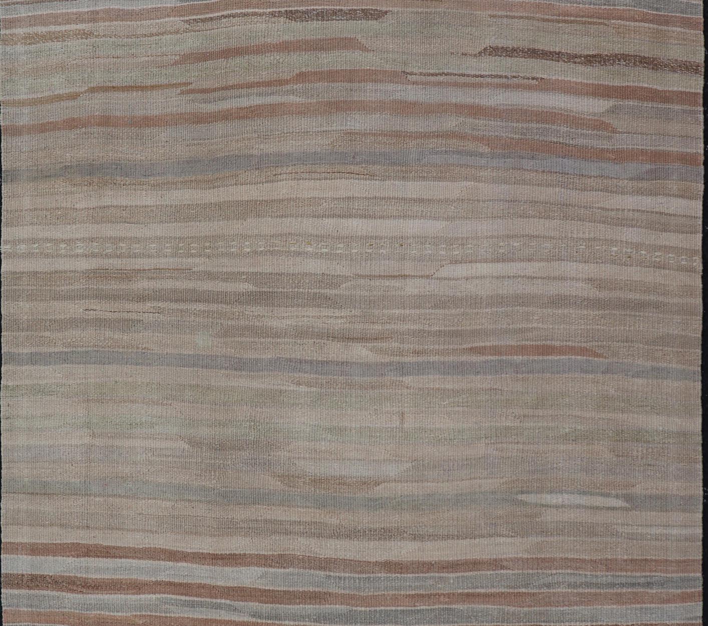 Minimalist Striped Design Vintage Turkish Kilim with Neutral Tones Measures 3'9 x 6'0 This wonderful piece features easy colors and a simple design. The palette consists of muted reds and blues, accenting the camel, fawn, and cocoa mass. ... - Keivan Woven ArtsEN - 13942 - 18926Rug