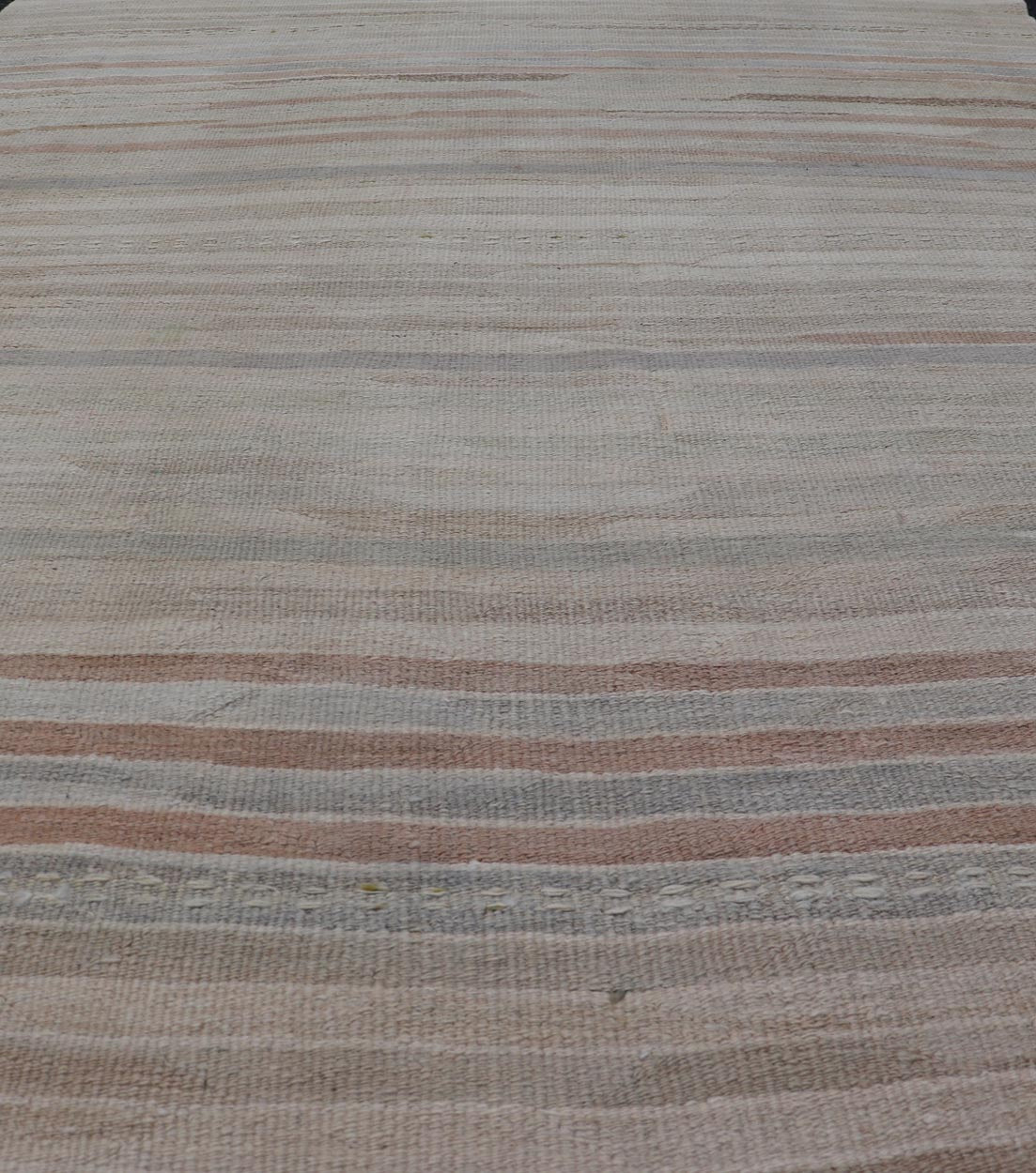 Minimalist Striped Design Vintage Turkish Kilim with Neutral Tones Measures 3'9 x 6'0 This wonderful piece features easy colors and a simple design. The palette consists of muted reds and blues, accenting the camel, fawn, and cocoa mass. ... - Keivan Woven ArtsEN - 13942 - 18926Rug