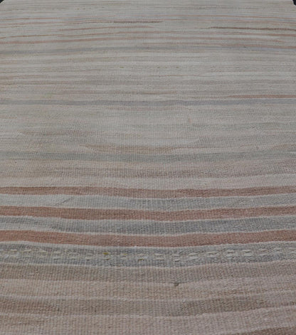 Minimalist Striped Design Vintage Turkish Kilim with Neutral Tones Measures 3'9 x 6'0 This wonderful piece features easy colors and a simple design. The palette consists of muted reds and blues, accenting the camel, fawn, and cocoa mass. ... - Keivan Woven ArtsEN - 13942 - 18926Rug