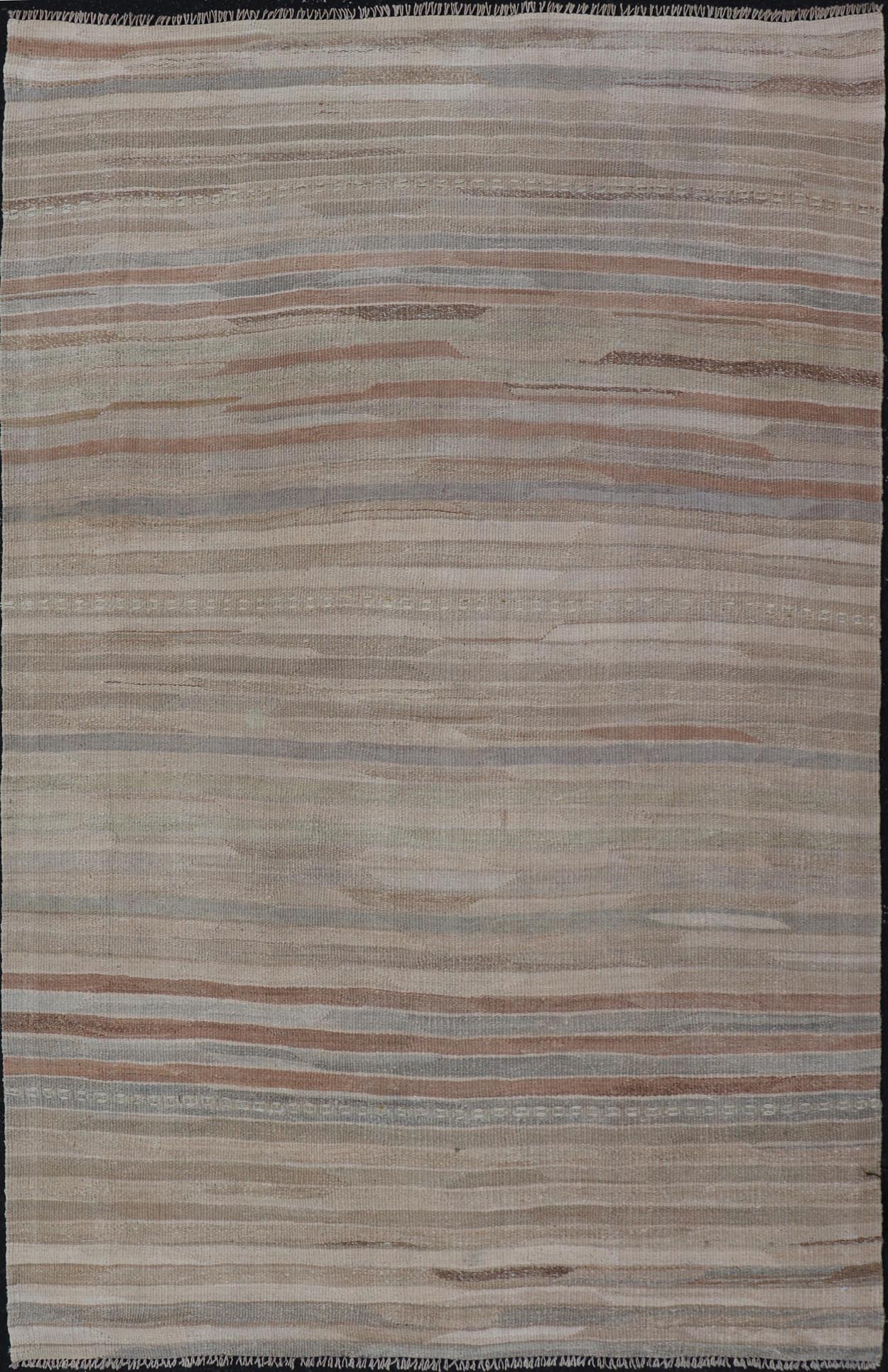 Minimalist Striped Design Vintage Turkish Kilim with Neutral Tones Measures 3'9 x 6'0 This wonderful piece features easy colors and a simple design. The palette consists of muted reds and blues, accenting the camel, fawn, and cocoa mass. ... - Keivan Woven ArtsEN - 13942 - 18926Rug