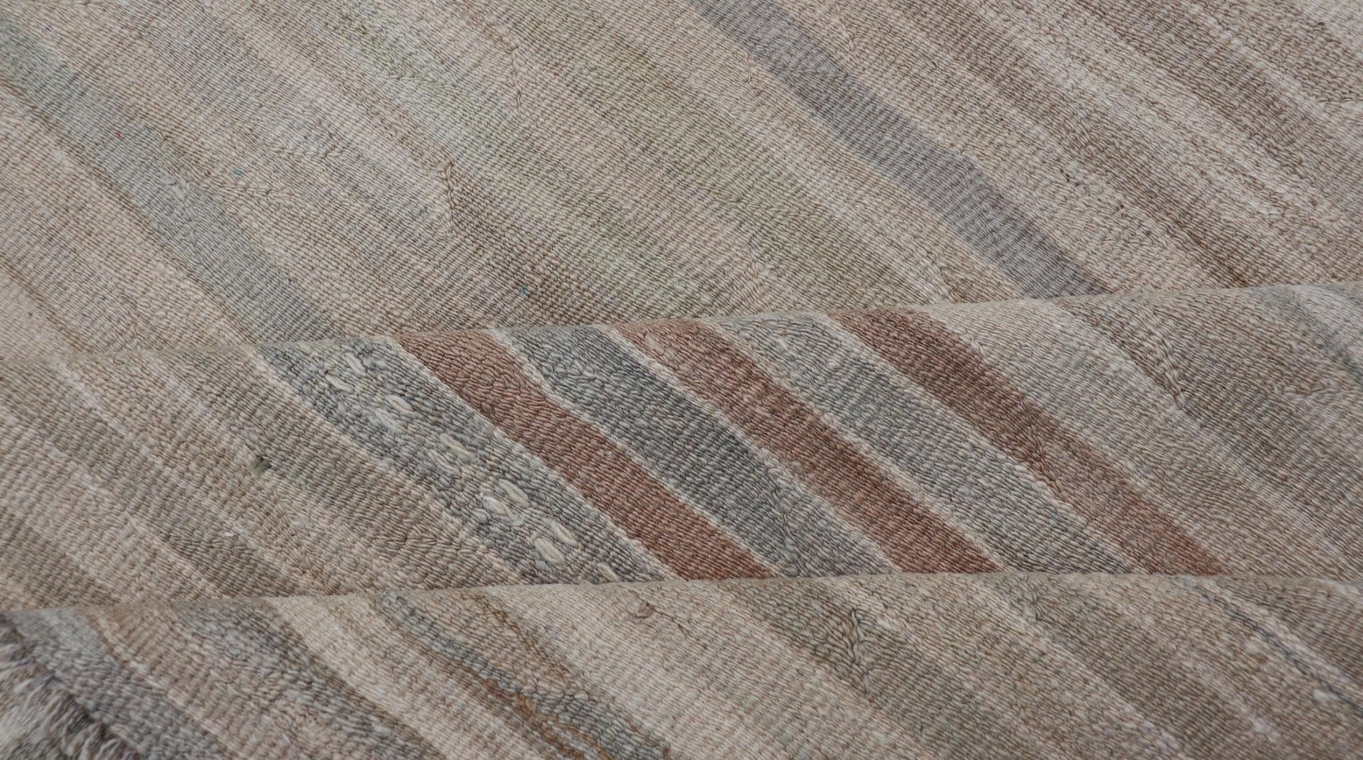 Minimalist Striped Design Vintage Turkish Kilim with Neutral Tones Measures 3'9 x 6'0 This wonderful piece features easy colors and a simple design. The palette consists of muted reds and blues, accenting the camel, fawn, and cocoa mass. ... - Keivan Woven ArtsEN - 13942 - 18926Rug