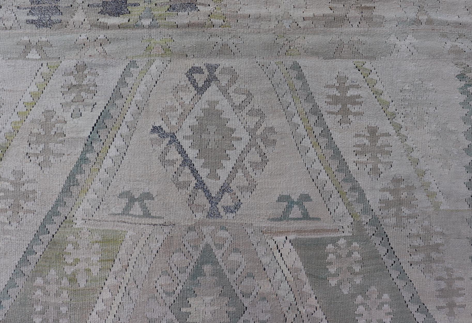 Vintage Hand - Woven Turkish Kilim in Wool with Medallion Sub - Geometric Design This flat - weave tribal Turkish kilim has been hand - woven in wool. The rug features an all - over sub - geometric medallion design, rendered in greens, blues and neutra... - Keivan Woven ArtsEN - 13963 - 19496