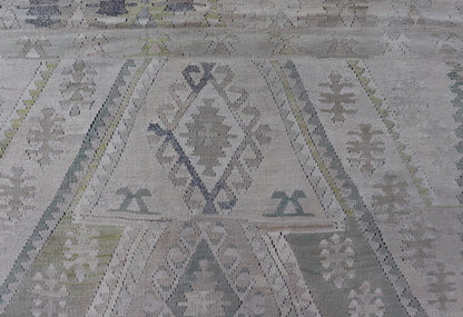Vintage Hand - Woven Turkish Kilim in Wool with Medallion Sub - Geometric Design This flat - weave tribal Turkish kilim has been hand - woven in wool. The rug features an all - over sub - geometric medallion design, rendered in greens, blues and neutra... - Keivan Woven ArtsEN - 13963 - 19496