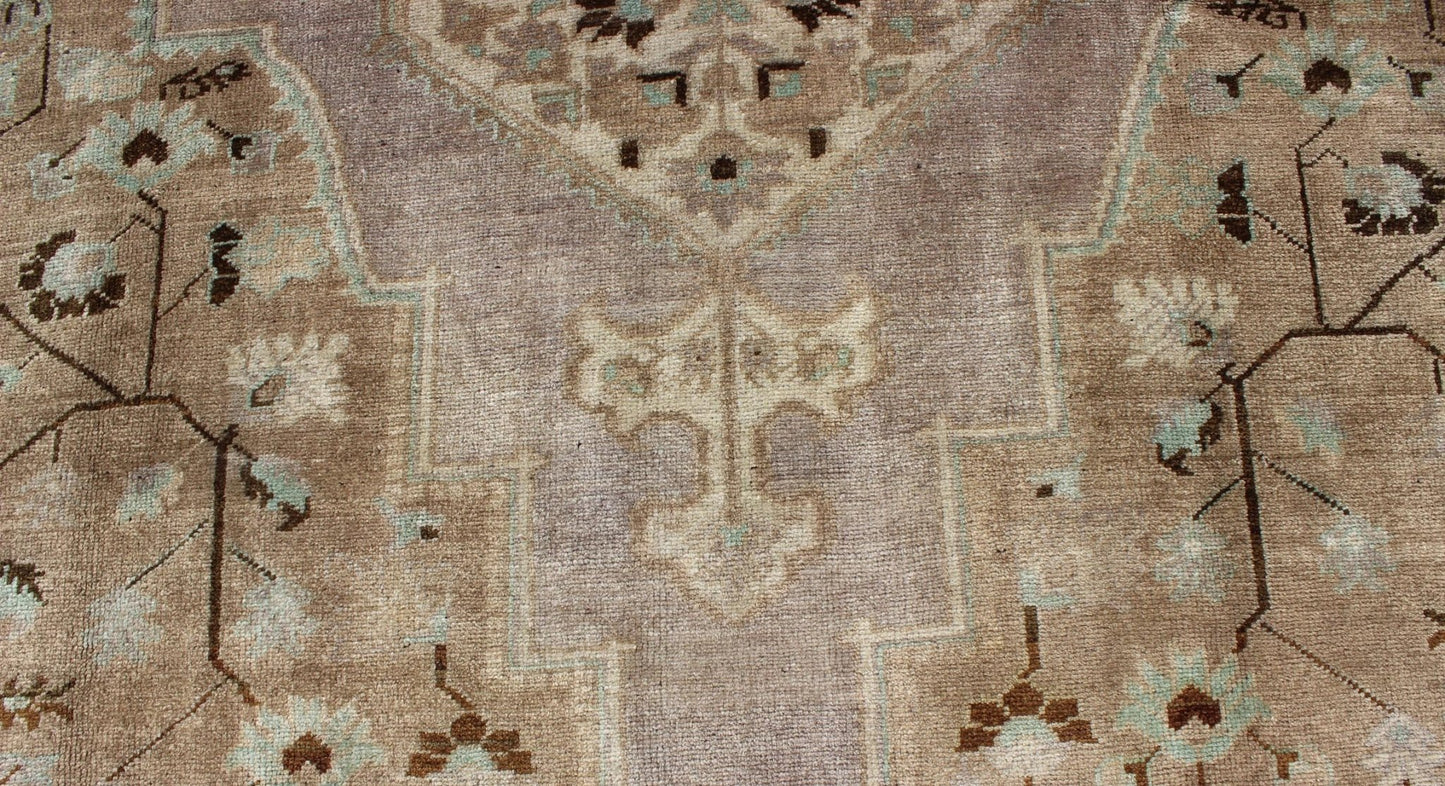 Vintage Turkish Floral Medallion Oushak in Earth Tones, Lavender, and Ice Blue Measures: 7'2 x 11'0 This stunning vintage Turkish Oushak carpet (circa mid - 20th century) features a central medallion with floral motifs and subtle sub - geome... - Keivan Woven ArtsEN - 140042 - 5550Rug