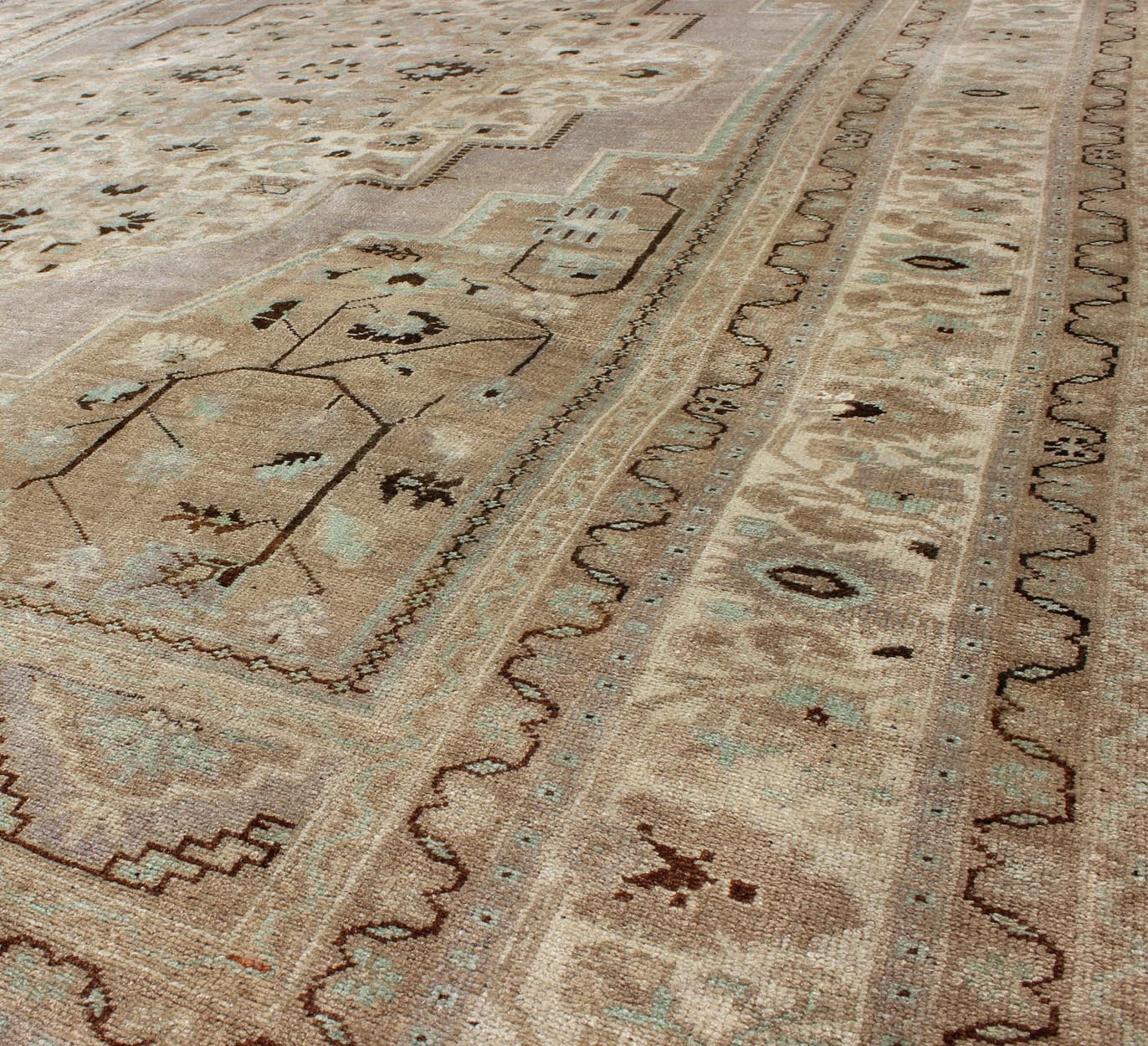 Vintage Turkish Floral Medallion Oushak in Earth Tones, Lavender, and Ice Blue Measures: 7'2 x 11'0 This stunning vintage Turkish Oushak carpet (circa mid - 20th century) features a central medallion with floral motifs and subtle sub - geome... - Keivan Woven ArtsEN - 140042 - 5550Rug