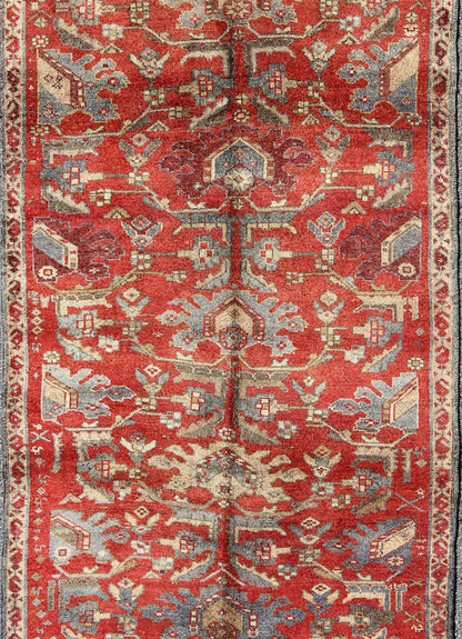Red Turkish Oushak with Flowing Tribal Design in Red, Blue, and Gray This vintage Oushak rug features an intricate and complex design paired with a unique color combination. Flowing tribal motifs spread across the central field and are surrounde... - Keivan Woven ArtsEN - 140062 - 6027Rug