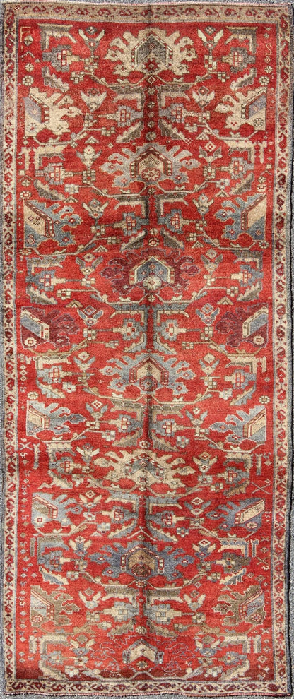 Red Turkish Oushak with Flowing Tribal Design in Red, Blue, and Gray This vintage Oushak rug features an intricate and complex design paired with a unique color combination. Flowing tribal motifs spread across the central field and are surrounde... - Keivan Woven ArtsEN - 140062 - 6027Rug