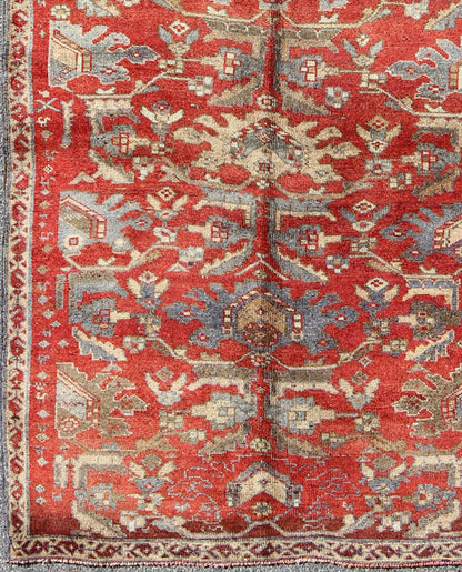 Red Turkish Oushak with Flowing Tribal Design in Red, Blue, and Gray This vintage Oushak rug features an intricate and complex design paired with a unique color combination. Flowing tribal motifs spread across the central field and are surrounde... - Keivan Woven ArtsEN - 140062 - 6027Rug