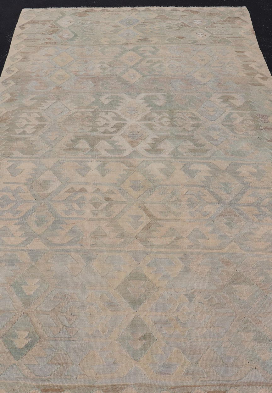 Gallery Turkish Vintage Flat - Weave Tribal Designed Kilim in Earthy Tones This vintage Turkish flat weave Kilim features tribal relics and faded earthy neutrals. The repeating design covers the entire field of muted light blue, caramel, taupe and gr... - Keivan Woven ArtsEN - 14037 - 23738Rug