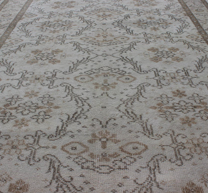 Vintage Turkish Oushak Carpet with Ivory Ground and Repeating Floral Design. Keivan Woven Arts / circa/1940 rug/ EN - 140436 Mid - 20th Century Vintage Oushak. Measures: 5'2 x 8'9. The design of this beautiful vintage Oushak rug from mid - 20th centu... - Keivan Woven ArtsEN - 140436 - 5664Rug