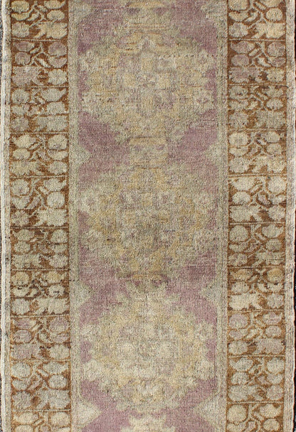 Vintage Oushak Runner This unique Turkish Oushak runner displays an elegant multi floral medallions which are complemented by a Sub geometric border. This rug has light purple background with dark brown, light blue, cream, green and taupe. Me... - Keivan Woven ArtsEN - 140539 - 6077Rug