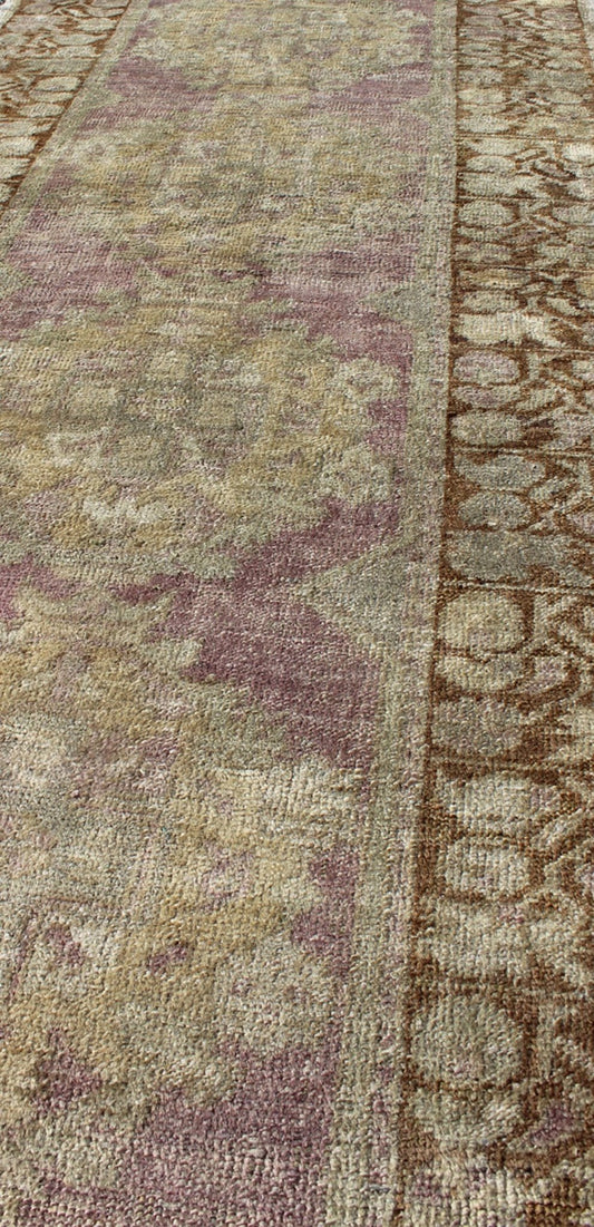 Vintage Oushak Runner This unique Turkish Oushak runner displays an elegant multi floral medallions which are complemented by a Sub geometric border. This rug has light purple background with dark brown, light blue, cream, green and taupe. Me... - Keivan Woven ArtsEN - 140539 - 6077