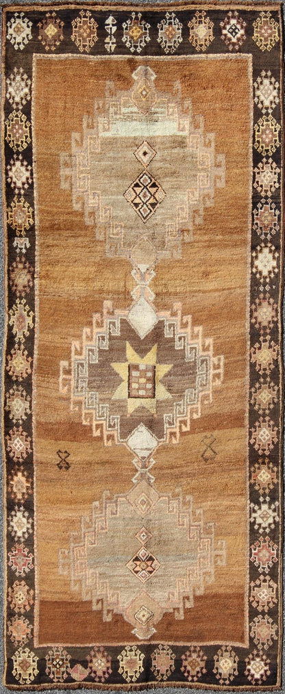 Vintage Turkish Kars Tribal Medallion Runner in Camel, Brown, and Taupe Measures: 4'6 x 10'11 This Kars Oushak features a triple center medallion with an overall geometric design scheme. The camel colored background homes three large tri... - Keivan Woven ArtsEN - 140562 - 5684Rug