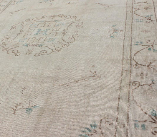 Vintage Khotan Design Rug in Neutrals, Cream, Light Blue, Light Brown & Colors with small circular medallion in buff and cream background with Neutral Colors, Light Blue, Light Brown. Keivan Woven Arts /rug EN - 140565 , country of origin / type: Turkey ... - Keivan Woven ArtsEN - 140565 - 5696Rug