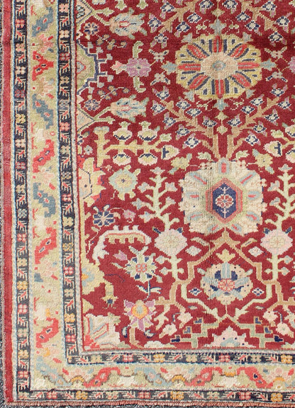 Colorful Turkish Oushak Carpet with Scattered Vines and Flowers on a Red Field Oushak Carpet with Scattered Vines and Flowers on a Red Field rug/en - 141107 origin/ turkey kwarugs Handwoven in Turkey, this antique Oushak rug features scatte... - Keivan Woven ArtsEN - 141107 - 7145Rug