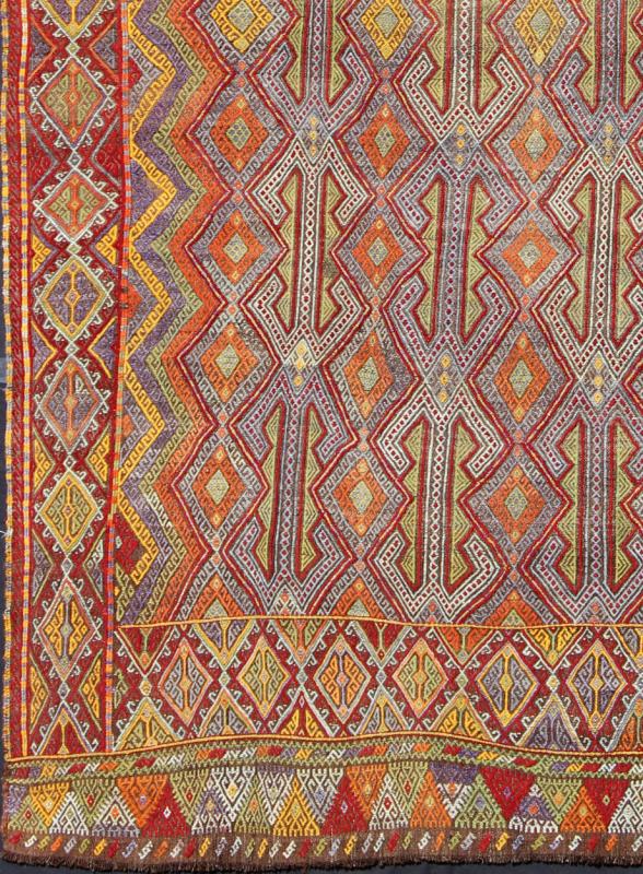 Large Vintage Turkish Embroidered Kilim in Bright and Colorful Tones Measures: 7'4'' x 10'11''. Featuring tribal shapes with a spotted and speckled assortment of geometric elements, this unique Jajeem / Jejim showcases an array of rich color... - Keivan Woven ArtsEN - 141128 - 7155Rug