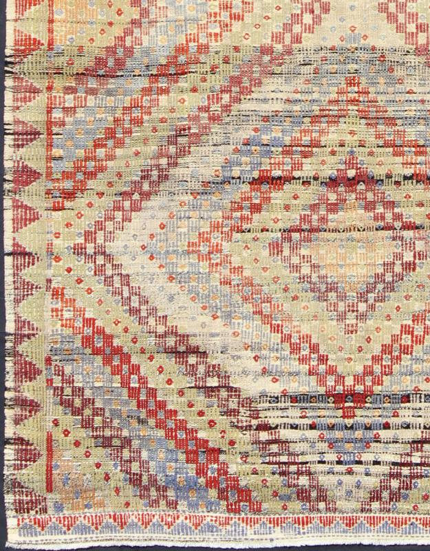 Vintage Turkish Embroidered Kilim in Green, Red and Light Blue Measures: 6'9'' x 10'9''. Featuring a large diamond pattern with a spotted and speckled assortment of geometric checkered elements, this unique vintage Kilim showcases an array of... - Keivan Woven ArtsEN - 141134 - 7159Rug