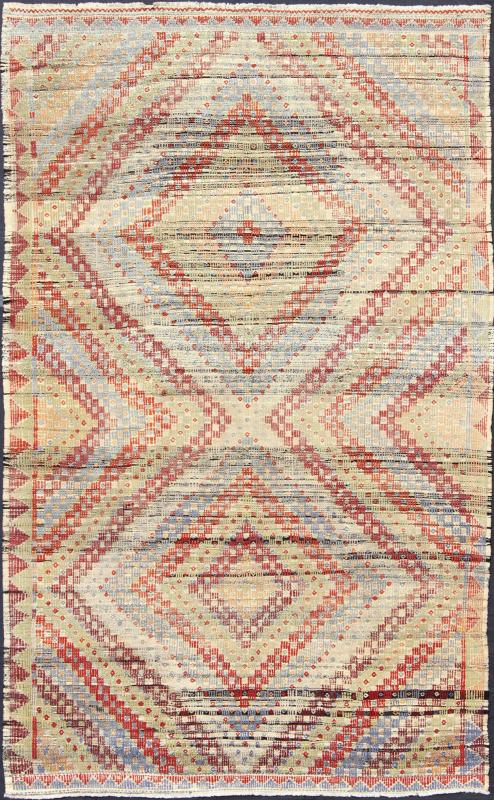 Vintage Turkish Embroidered Kilim in Green, Red and Light Blue Measures: 6'9'' x 10'9''. Featuring a large diamond pattern with a spotted and speckled assortment of geometric checkered elements, this unique vintage Kilim showcases an array of... - Keivan Woven ArtsEN - 141134 - 7159Rug