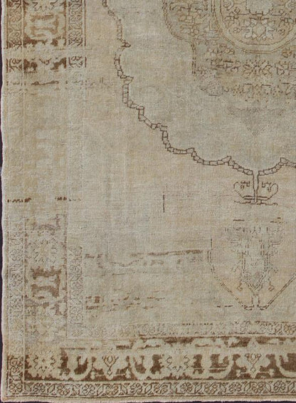 Antique Oushak Carpet in Taupe, Brown, Light Celadon Green and Neutral Colors Measures: 8'0'' x 12'1''. This antique Oushak wool rug features an over - sized medallion with detailed vines and flowers. A framework of floral motifs and styliz... - Keivan Woven ArtsEN - 141449 - 7203Rug